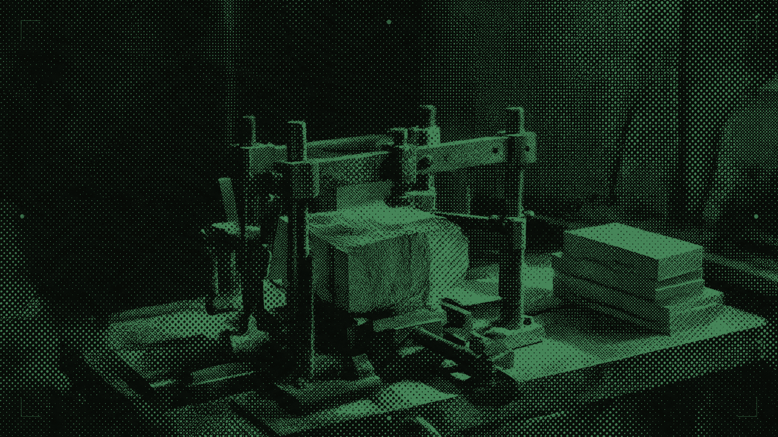A rough wooden block held in a metal jig beside identical polished blocks