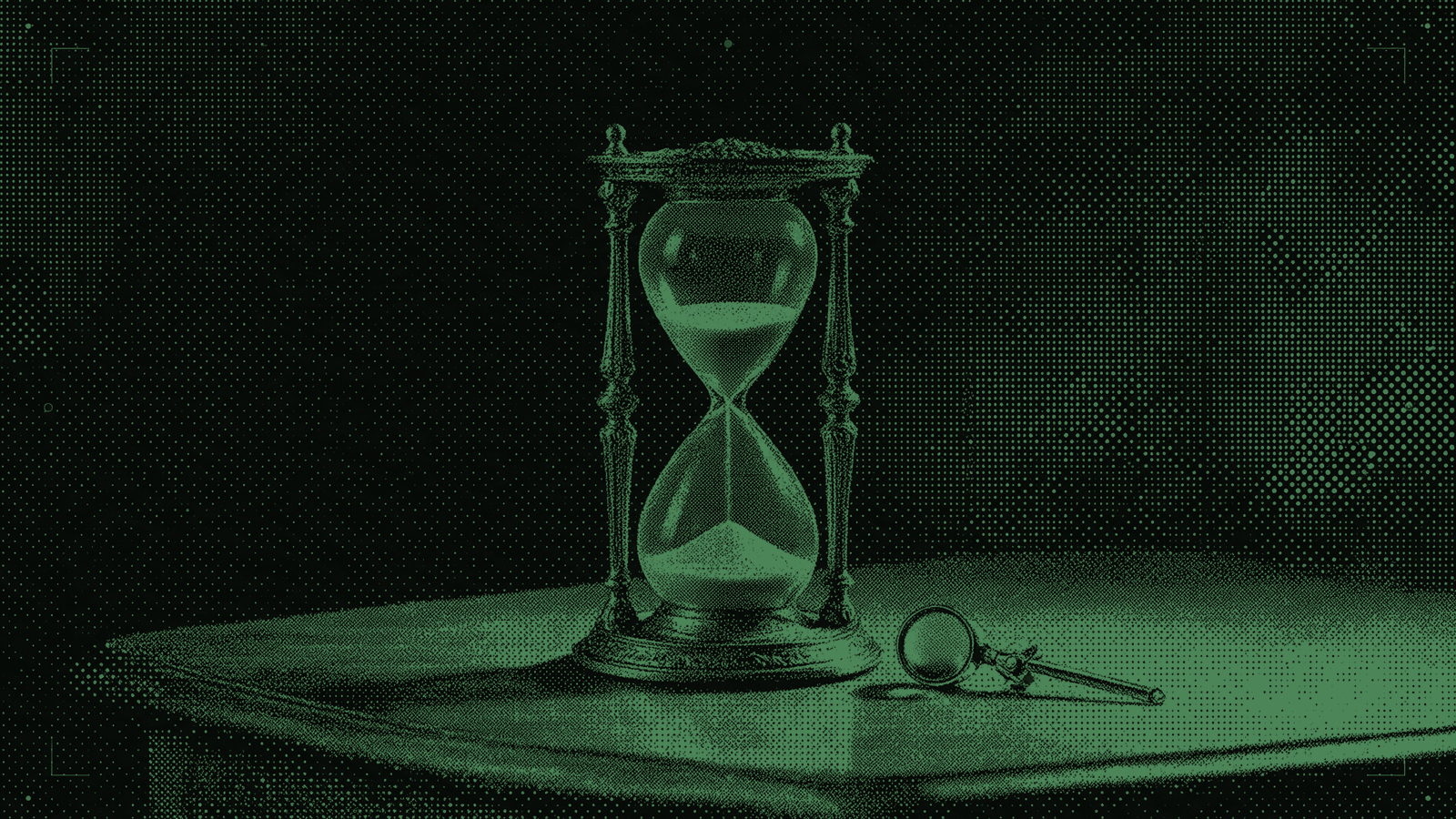 An antique hourglass with the sand half run through and a jeweller’s loupe lying beside it