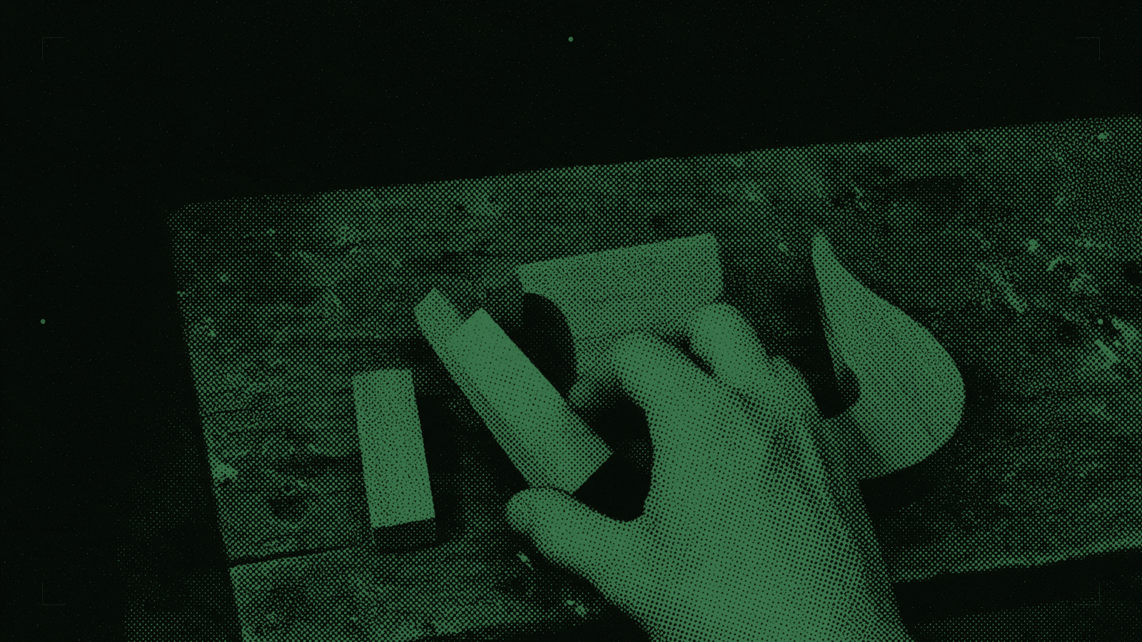 A hand lifts a plain wooden piece beside two alternative pieces on a dark workbench