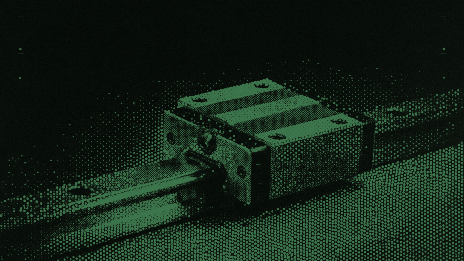 A hardened steel end-stop bolted to a linear guide rail, the sliding carriage resting hard against it
