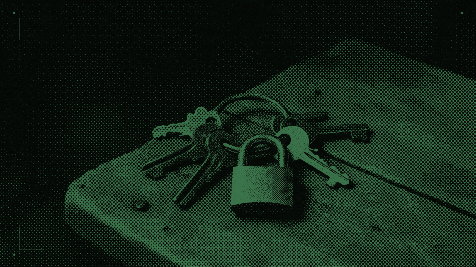 A ring of antique keys of different wards, with a single brass lock in front of them